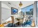 Bright dining room with elegant chandelier, glass table, and expansive windows offering city views at 155 S Court Ave # 1602, Orlando, FL 32801