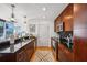 Modern kitchen featuring sleek cabinetry, black countertops, and stainless steel appliances at 155 S Court Ave # 1602, Orlando, FL 32801