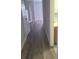 Inviting hallway featuring wood-style flooring and neutral paint, leading to various rooms at 3946 Versailles Dr # 3946B, Orlando, FL 32808