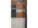 Functional kitchen equipped with black appliances, neutral countertops, and tile flooring at 3946 Versailles Dr # 3946B, Orlando, FL 32808