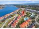 Scenic aerial view of community with a pool, waterfront access, and meticulously kept grounds at 445 Bouchelle Dr # 202, New Smyrna Beach, FL 32169