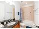 Well-lit bathroom featuring granite counters, a sink, toilet, and shower with patterned blue curtain at 1392 Indiana Ave, Winter Park, FL 32789