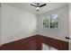 Bright bedroom featuring wood floors, a ceiling fan, and a window that provides ample natural light at 1392 Indiana Ave, Winter Park, FL 32789