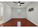 Spacious bedroom featuring hardwood floors, a ceiling fan, and lots of natural light from the windows at 1392 Indiana Ave, Winter Park, FL 32789