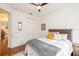 Inviting bedroom with hardwood floors, a ceiling fan, and a cozy bed with stylish accents at 1392 Indiana Ave, Winter Park, FL 32789