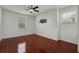 Bright bedroom with hardwood floors, two large windows, and ceiling fan offering a relaxing atmosphere at 1392 Indiana Ave, Winter Park, FL 32789