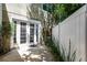 Private outdoor patio featuring white vinyl fence and french doors to the interior at 1392 Indiana Ave, Winter Park, FL 32789