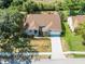Expansive aerial view of a well-maintained home featuring a large roof, manicured lawn, and a spacious driveway at 2226 Lake Marion Dr, Apopka, FL 32712