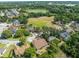 Scenic aerial shot of a neighborhood with lush greenery, a pond, and well-spaced homes, offering a serene living environment at 2226 Lake Marion Dr, Apopka, FL 32712