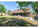 A fenced backyard features a screened lanai, bench, and mature landscaping, perfect for outdoor enjoyment at 2226 Lake Marion Dr, Apopka, FL 32712