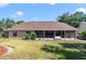 A spacious backyard with a screened-in lanai, bench, and manicured landscaping offers outdoor tranquility at 2226 Lake Marion Dr, Apopka, FL 32712