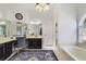 Elegant bathroom with a stylish vanity, beautiful mirror, and a luxurious bathtub for relaxation at 2226 Lake Marion Dr, Apopka, FL 32712
