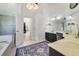 Bright bathroom showcasing a glass shower, double vanity, and a large window for natural light at 2226 Lake Marion Dr, Apopka, FL 32712