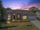 Charming single-story home with brick accents, manicured lawn, and a well-lit entrance, perfect for a welcoming curb appeal at 2226 Lake Marion Dr, Apopka, FL 32712