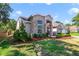 Beautiful home featuring a mix of brick and stucco, enhanced by well-kept landscaping and lush green lawn at 2226 Lake Marion Dr, Apopka, FL 32712