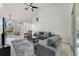 Bright living room with high ceilings, neutral tones, and plush gray sofas at 2226 Lake Marion Dr, Apopka, FL 32712