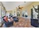A covered patio featuring tile floors, ceiling fan, and comfortable wicker seating offers relaxed outdoor living at 2226 Lake Marion Dr, Apopka, FL 32712