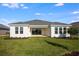 The backyard features lush green lawn and a home with a dark roof and white trim at 2956 Arranmore Dr, Ormond Beach, FL 32174