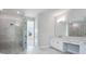 Bright Primary bathroom features a tile shower, vanity, and dual mirrors at 2956 Arranmore Dr, Ormond Beach, FL 32174