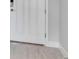 Close up of a white paneled entry door with nickel hardware and light wood flooring at 2956 Arranmore Dr, Ormond Beach, FL 32174