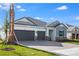 A home's exterior with a tile roof, two-car garage, and well-manicured landscaping at 2956 Arranmore Dr, Ormond Beach, FL 32174