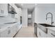 Bright kitchen features white cabinets, stainless steel appliances, and modern fixtures at 2956 Arranmore Dr, Ormond Beach, FL 32174