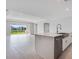 Bright living area showcases an island kitchen and backyard view through sliding glass doors at 2956 Arranmore Dr, Ormond Beach, FL 32174