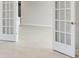 Bright living room view through french doors; neutral walls and flooring at 2956 Arranmore Dr, Ormond Beach, FL 32174