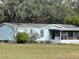 Quaint home featuring a screened-in porch and well-maintained lawn at 31029 Nocatee Trl, Sorrento, FL 32776