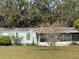 Cozy home featuring a screened porch and mature trees, offering a tranquil setting at 31029 Nocatee Trl, Sorrento, FL 32776