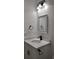 Features a well-lit vanity with a modern sink, stylish fixtures, and a sleek mirror for a minimalist design at 4655 Sw 139Th Ln, Ocala, FL 34473