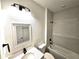 Bathroom featuring a built in bathtub, quartz countertop, and black matte fixtures at 4655 Sw 139Th Ln, Ocala, FL 34473