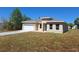 Charming tan single-Gathering home with a well-maintained lawn and driveway leading to the attached garage at 4655 Sw 139Th Ln, Ocala, FL 34473
