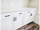 Kitchen cabinetry featuring quartz countertops, white cabinets, and black matte hardware at 4655 Sw 139Th Ln, Ocala, FL 34473