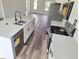 Modern kitchen featuring stainless steel appliances, a large island with a sink, and hardwood floors at 4655 Sw 139Th Ln, Ocala, FL 34473
