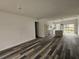 Spacious living room with sleek flooring, leading to an open-concept kitchen and sunlit patio at 4655 Sw 139Th Ln, Ocala, FL 34473