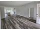 Spacious open-concept living area with sleek hardwood floors and a view of the kitchen island at 4655 Sw 139Th Ln, Ocala, FL 34473