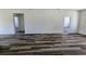 Spacious living room with wood flooring and neutral paint, showing two doorways at 4655 Sw 139Th Ln, Ocala, FL 34473