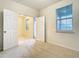 Bedroom with double doors, a window, neutral walls, and neutral carpet at 12285 Joshua Tree Trl, Windermere, FL 34786