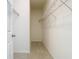 Walk-in closet with neutral carpet and walls and metal shelving for storage at 12285 Joshua Tree Trl, Windermere, FL 34786