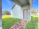 A well-maintained home exterior features a brick walkway leading to the front door and lush green lawn at 12285 Joshua Tree Trl, Windermere, FL 34786