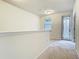 Bright loft area featuring neutral walls and carpet, a window, and access to a balcony at 12285 Joshua Tree Trl, Windermere, FL 34786