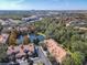 Stunning aerial view of townhomes with a central pond and fountain, nestled in lush greenery and foliage at 1300 Gilford Point Ln # 1300, Davenport, FL 33896