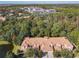 Lovely aerial view of townhomes surrounded by beautiful green trees and plants near a small pond at 1300 Gilford Point Ln # 1300, Davenport, FL 33896
