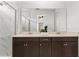 Modern bathroom featuring a double vanity, sleek countertops, and a large, framed mirror at 2097 Celebration Blvd, Celebration, FL 34747