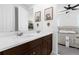 Bathroom with double sink vanity, framed monkey art, and access to bedroom at 2097 Celebration Blvd, Celebration, FL 34747
