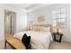 Cozy bedroom with a large bed, side tables, and bench, bathed in natural light at 2097 Celebration Blvd, Celebration, FL 34747