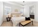 Bright bedroom featuring a large bed, stylish furnishings, and an ensuite bathroom at 2097 Celebration Blvd, Celebration, FL 34747