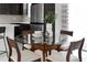Dining area featuring a round glass table and chairs, next to a kitchen with stainless steel appliances at 2097 Celebration Blvd, Celebration, FL 34747