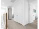 Upstairs hallway with white walls, doors, and neutral carpet at 2097 Celebration Blvd, Celebration, FL 34747